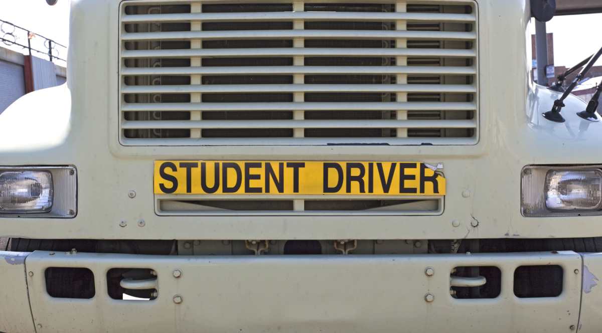 STUDENT DRIVER sign on front of semi truck